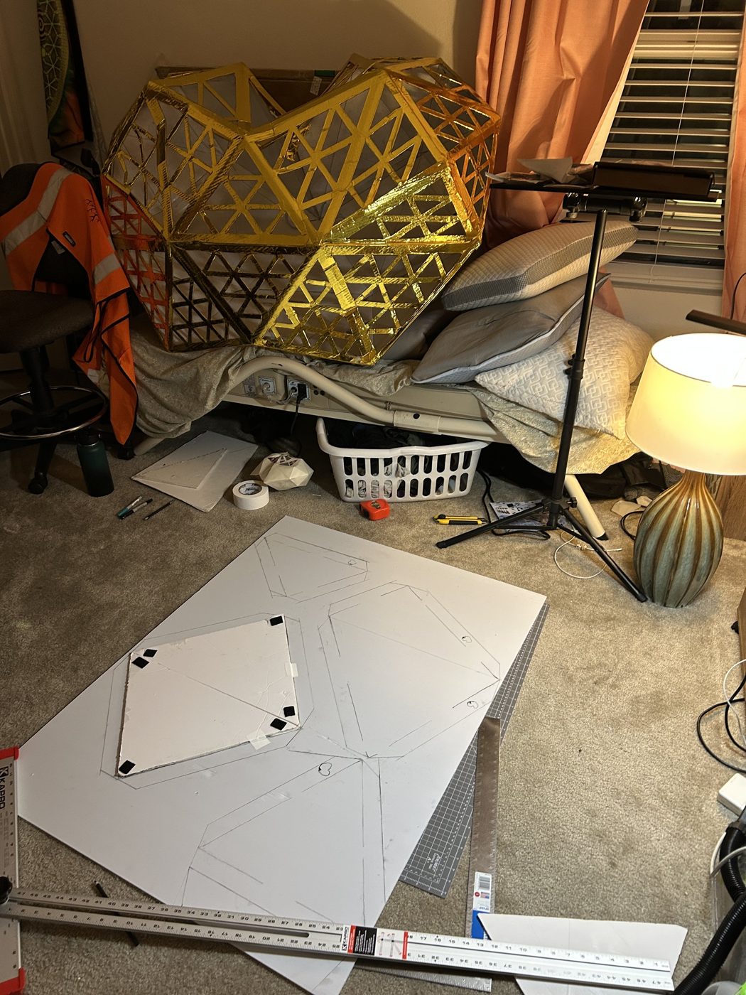 Drafting v1 panel layouts on corrugated plastic with the 2024 golden heart standing behind